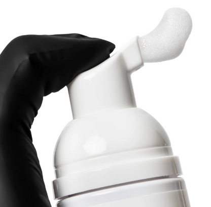 Bottles of Elleebana foaming lash and brow cleanser with pop-art style label design for professional prep and salon retail.