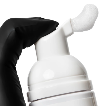 Bottles of Elleebana foaming lash and brow cleanser with pop-art style label design for professional prep and salon retail.