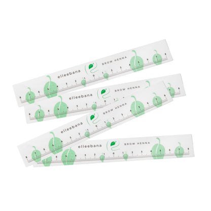 Roll of clear self-adhesive ruler stickers designed for accurate eyebrow mapping and ensuring symmetrical measurements during PMU, microblading, and brow styling procedures.