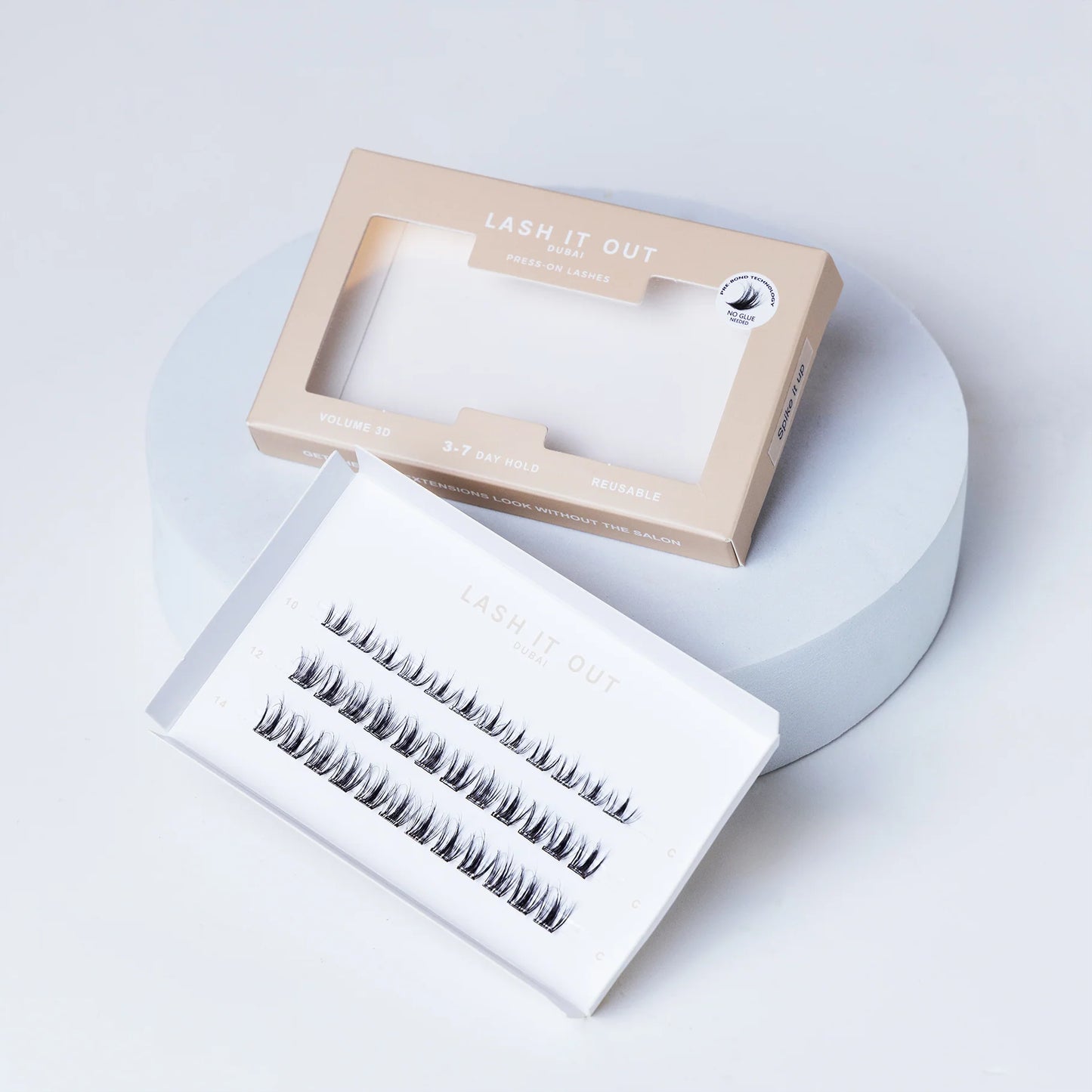 Lash It Out Pre-Glued Under-Lash Extensions Kit featuring 30 pre-glued cluster lashes in 10mm, 12mm, and 14mm lengths with a soft, crisscross design.