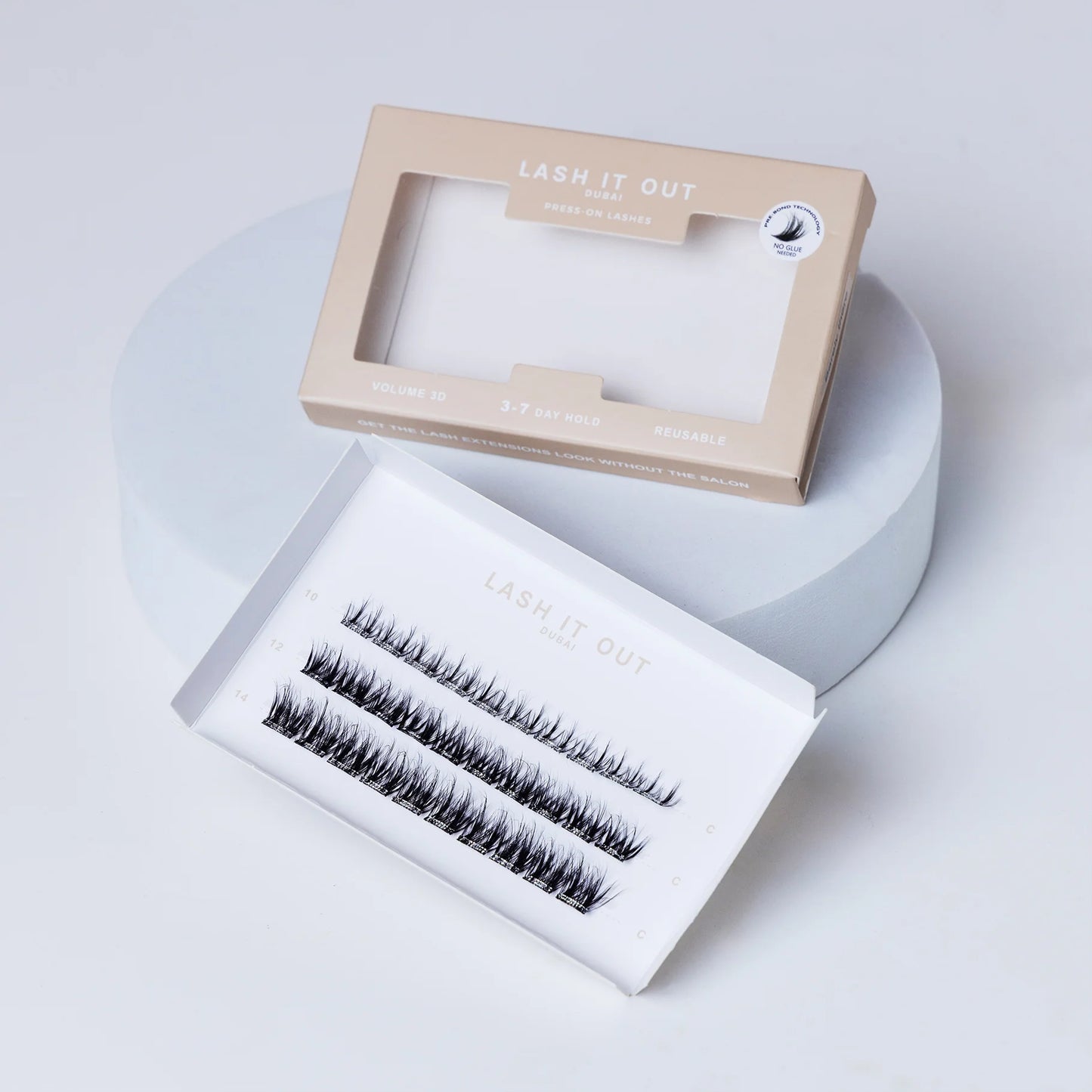 Lash It Out Pre-Glued Under-Lash Extensions Kit featuring 30 pre-glued cluster lashes in 10mm, 12mm, and 14mm lengths with a soft, crisscross design.