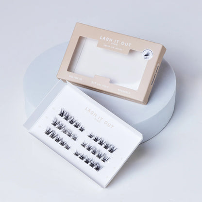 Lash It Out Pre-Glued Under-Lash Extensions Kit featuring 30 pre-glued cluster lashes in 10mm, 12mm, and 14mm lengths with a soft, crisscross design.