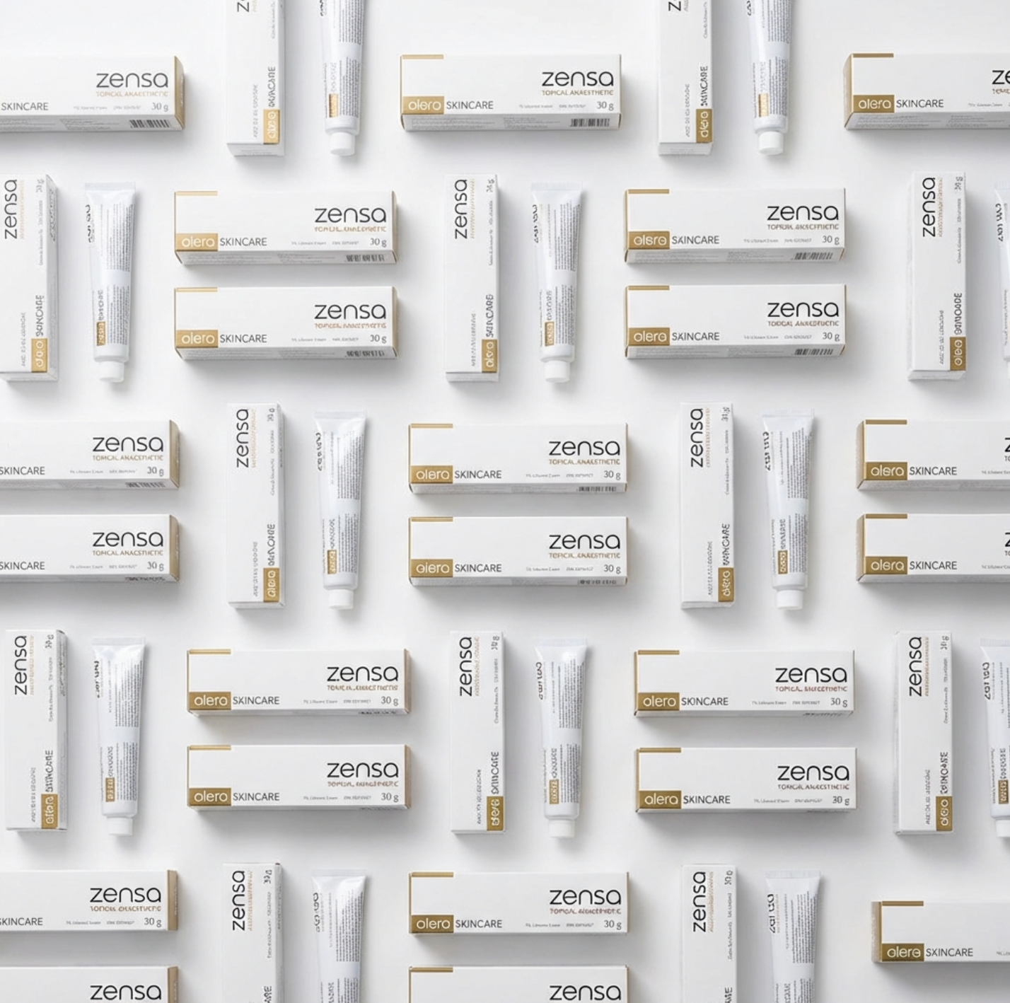 A bulk display of twenty-four 30g tubes of Zensa Pre-Procedure Numbing Cream neatly arranged for professional clinic and training academy use.