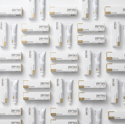A bulk display of twenty-four 30g tubes of Zensa Pre-Procedure Numbing Cream neatly arranged for professional clinic and training academy use.
