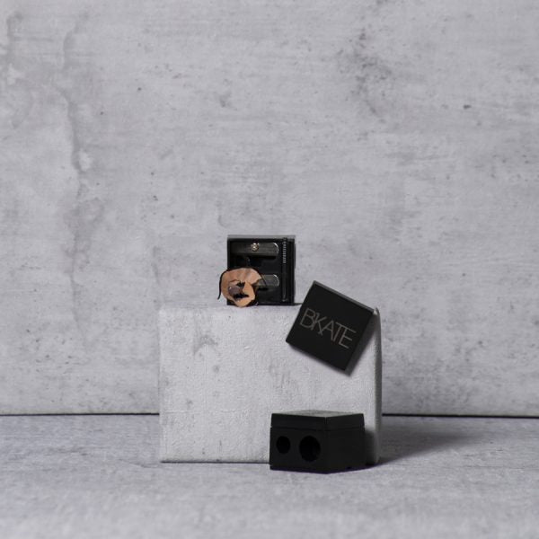 Dual-size B'KATE cosmetic pencil sharpener designed for sharpening makeup tools including brow pencils and highlighters.