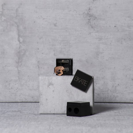 Dual-size B'KATE cosmetic pencil sharpener designed for sharpening makeup tools including brow pencils and highlighters.