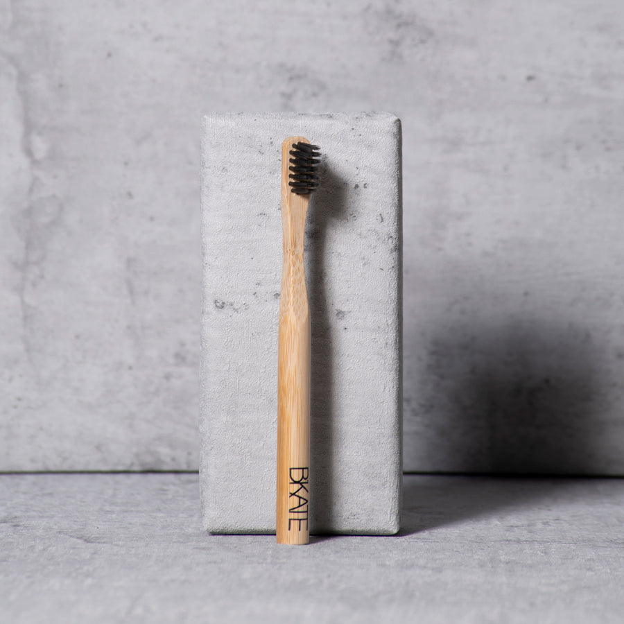B'KATE ecological bamboo eyebrow brush with compact bristles designed for applying brow soap or puff products to shape full, fluffy eyebrows.