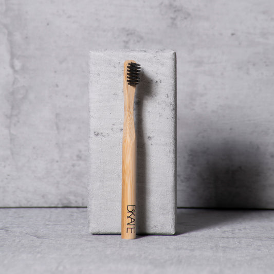 B'KATE ecological bamboo eyebrow brush with compact bristles designed for applying brow soap or puff products to shape full, fluffy eyebrows.