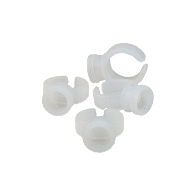 Pink plastic disposable pigment ring cups worn on a finger for easy microblading pigment or lash extension adhesive access.
