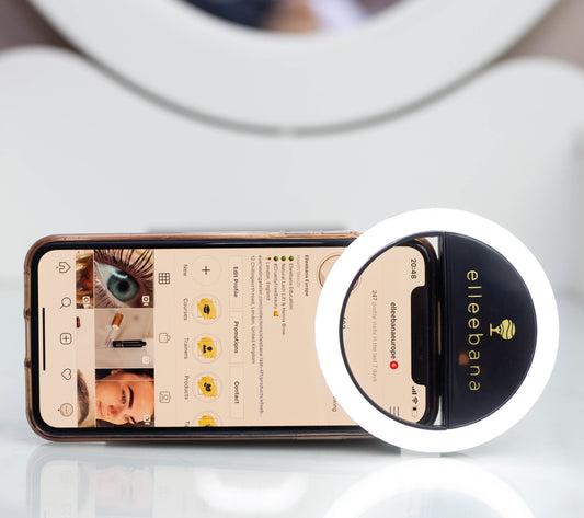Sleek black clip-on ring light designed for smartphones to illuminate close-up beauty photography, featuring adjustable brightness levels for clear before-and-after eyebrow and lash results.