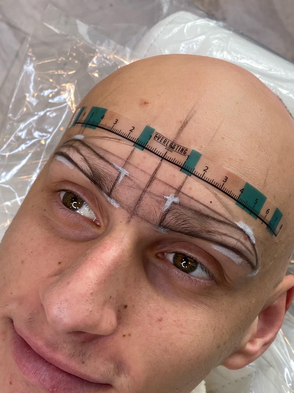 High-definition close-up result of permanent eyebrow microblading and combination ombre shading performed on a client.