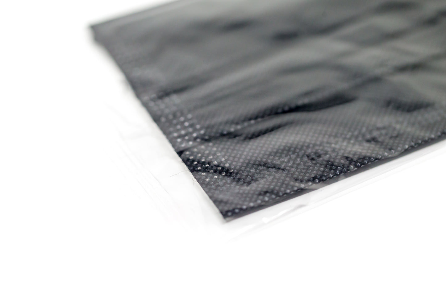 Medical-grade 3-ply blue disposable face mask in individual sterile plastic wrapping being pulled from a box, featuring soft earloops and fluid-resistant layers.