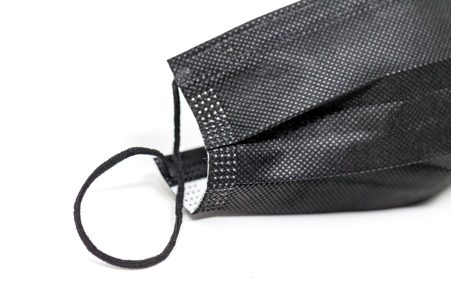 Medical-grade 3-ply blue disposable face mask in individual sterile plastic wrapping being pulled from a box, featuring soft earloops and fluid-resistant layers.